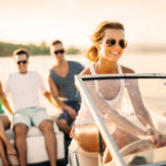 Young girl riding a speedboat.