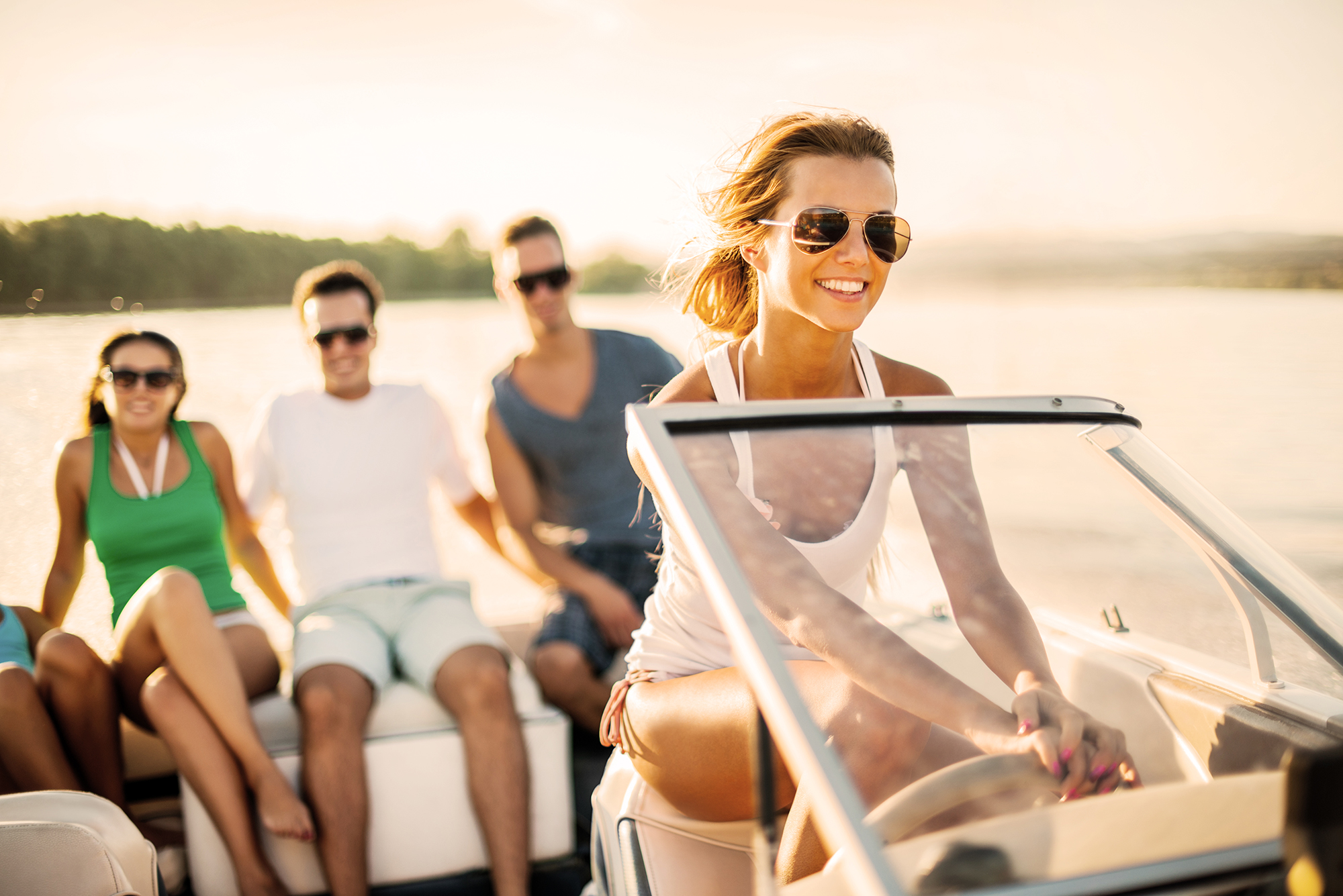 Young girl riding a speedboat.